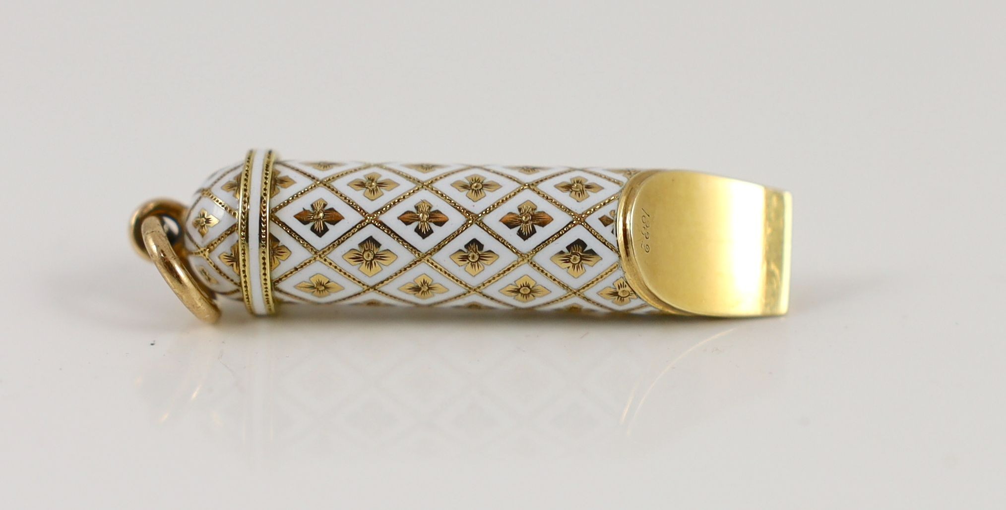 An early 20th century French 18ct gold and white enamel set novelty pendant, modelled as a whistle